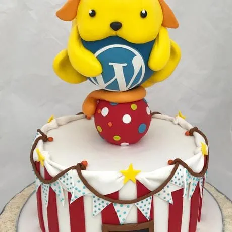A circus cake with a yellow fondant Wapuu on a spotted ball